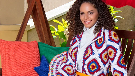 Colourful crochet cardigan and cushions pictured in Elite Yarns’ YarnArt collection